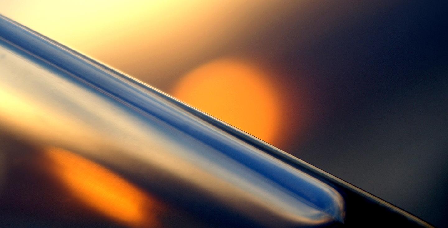 Refraction 1-2, a picture showing a reflection of a orange light in a glass like surface